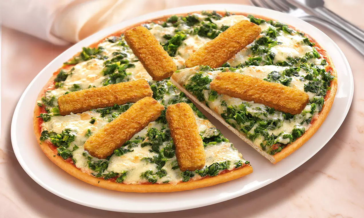 Runde Pizza mit knusprigem Rand, saftigem Spinat und geschmolzenem Käse, belegt mit goldbraunen Fischstäbchen auf weißem Teller